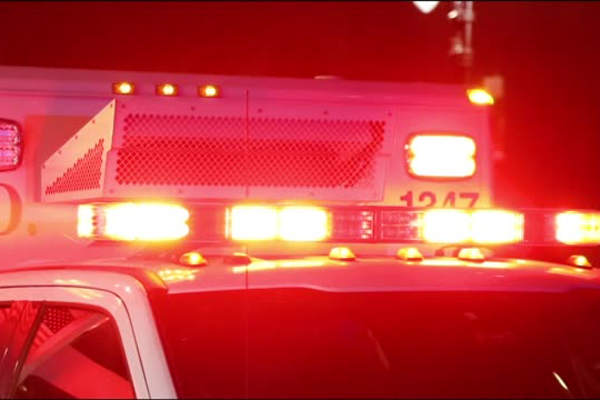 Ambulance lights flashing at night downtown